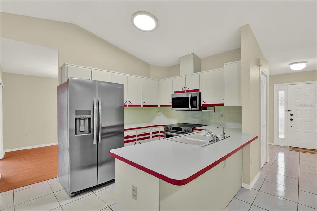 1503 Overland Drive Spring Hill, FL 34608 - Photo 8 of 24 a kitchen that has a refrigerator a stove and a sink