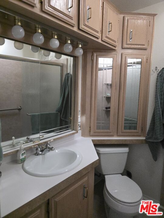 84136 Ave 44, Unit 660 Indio, CA 92203 - Photo 14 of 16 a bathroom with a sink toilet and shower