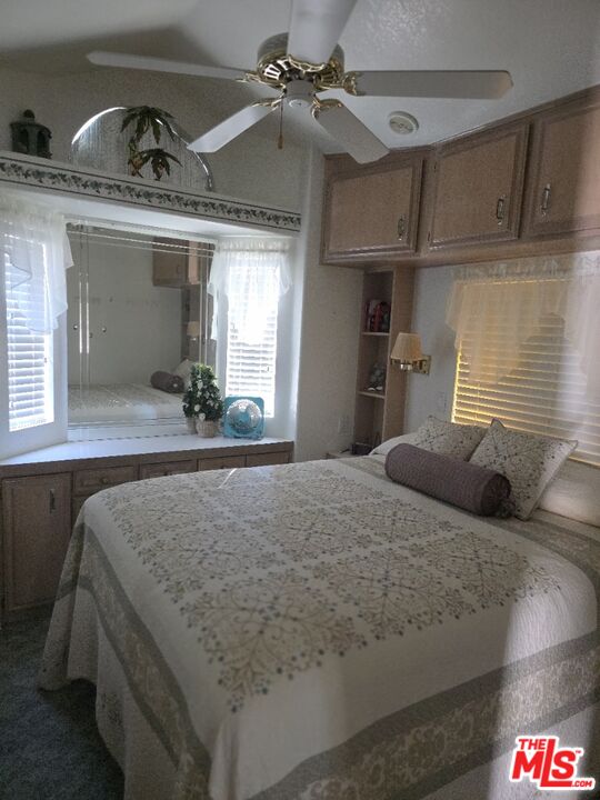 84136 Ave 44, Unit 660 Indio, CA 92203 - Photo 15 of 16 a bedroom with a bed and a dresser