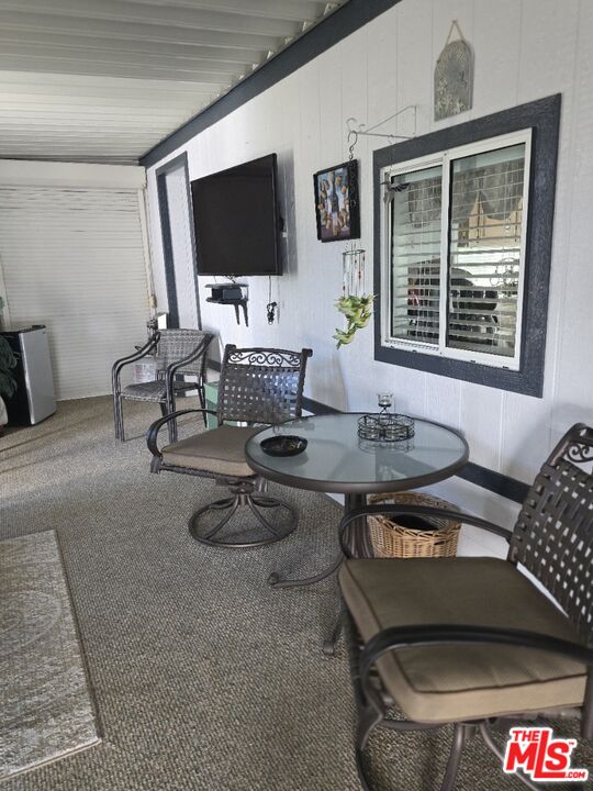 84136 Ave 44, Unit 660 Indio, CA 92203 - Photo 5 of 16 a living room with furniture and a flat screen tv