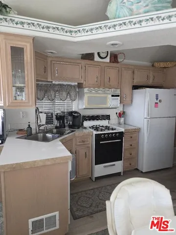 a white refrigerator freezer sitting inside of a kitchen