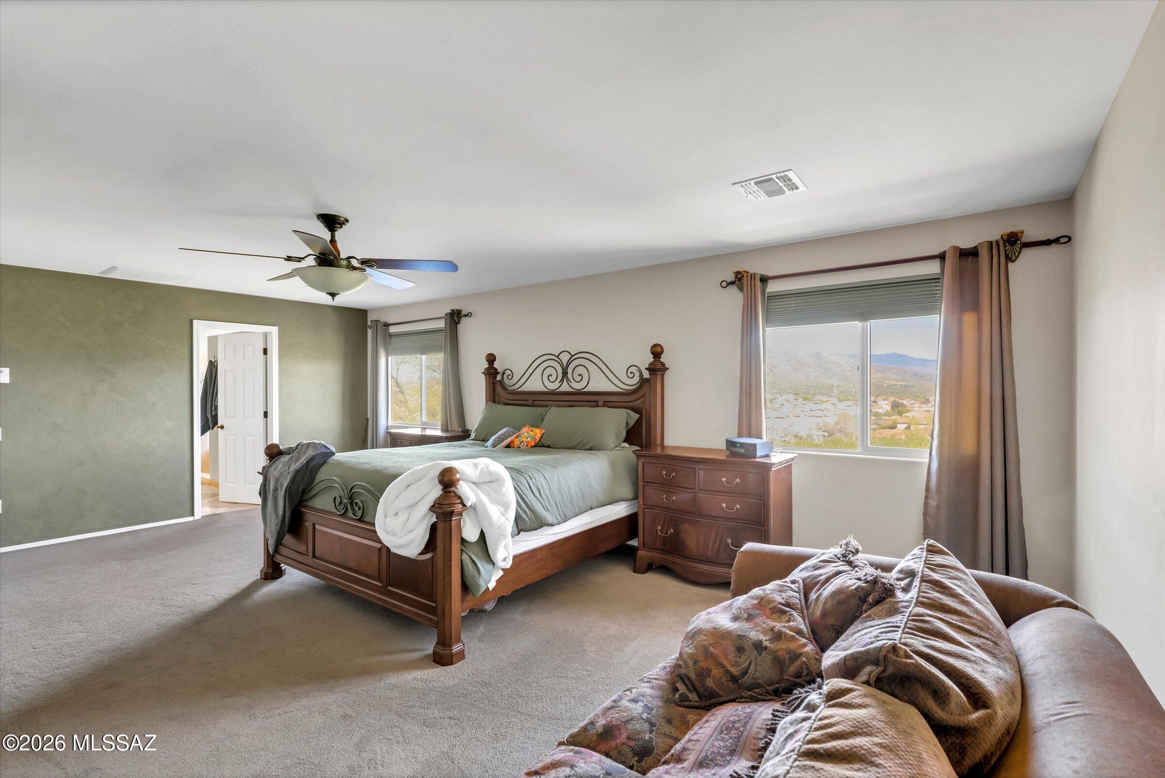 6095 South Jakemp Trail Tucson, AZ 85747 - Photo 26 of 52 a bedroom with a bed and window