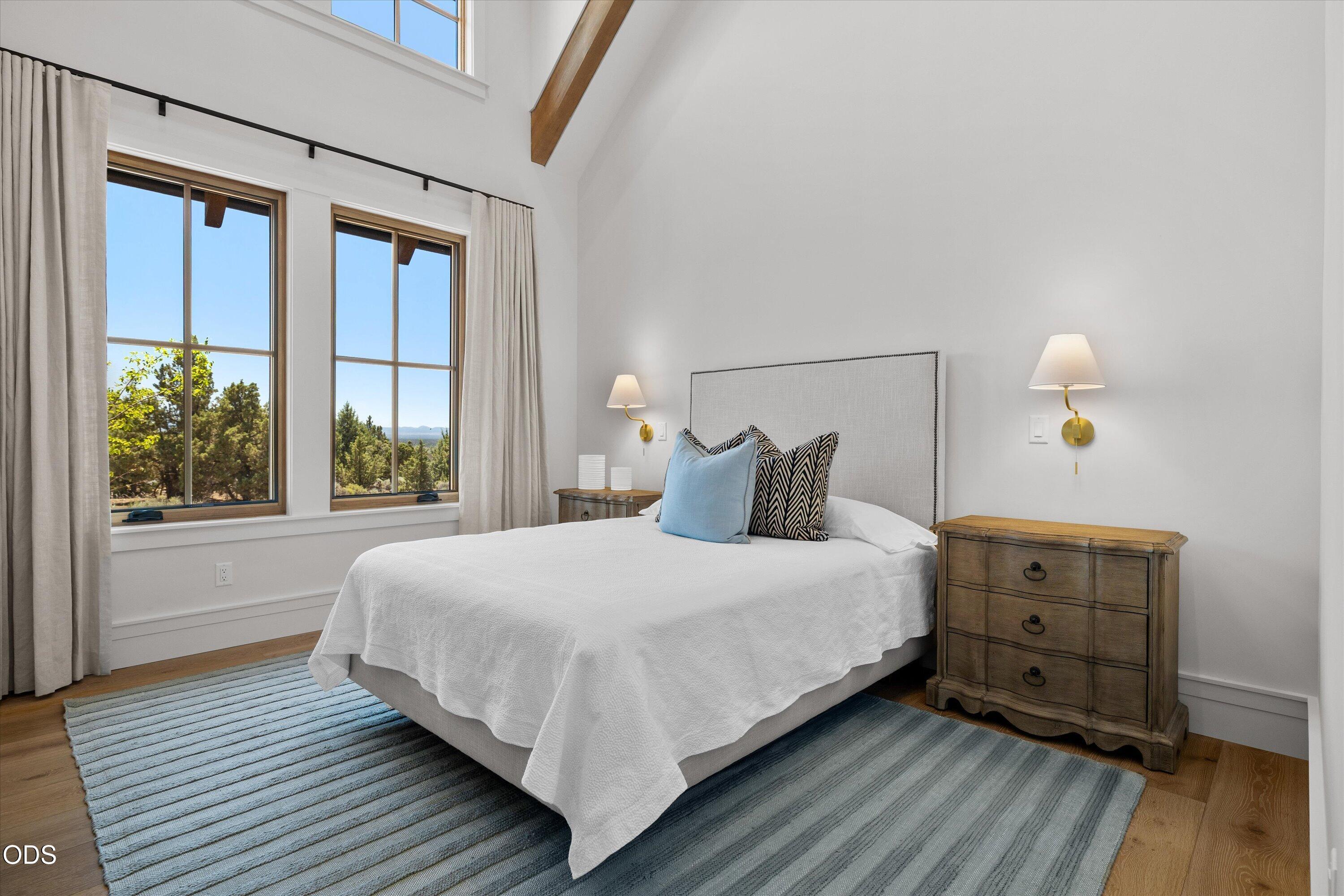 16215 South W Vaqueros Way Powell Butte, OR 97753 - Photo 25 of 48 The second guest suite is framed by more high ceilings, beams, and natural light