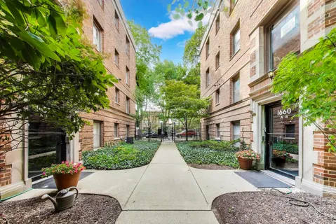 a view of a large building with a tree