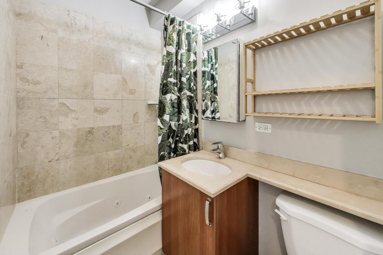 1658 West Farwell Avenue, Unit GC Chicago, IL 60626 - Photo 10 of 20 a bathroom with a sink and a mirror
