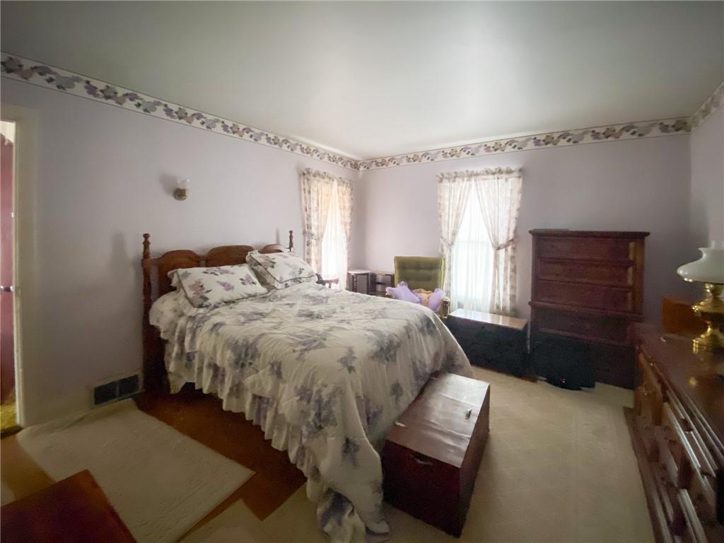 433 Pinney Street Rochester, PA 15074 - Photo 8 of 11 a bedroom with a bed and a dresser with the bookshelf