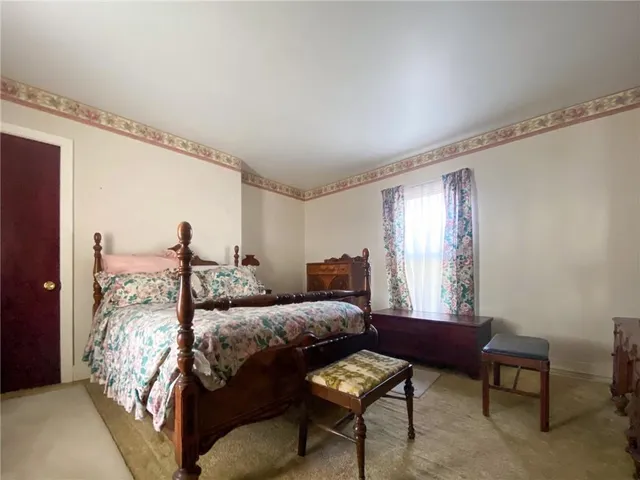 a bedroom with furniture and a window