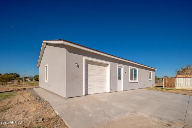 a view of a dirt road and a building