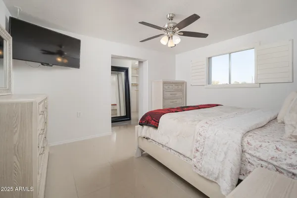 a living room with a bed furniture and a flat tv screen
