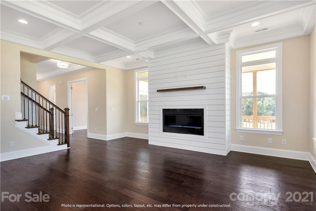 357 Grassy Rdg Court, Unit 50 Clover, SC 29710 - Photo 11 of 27 an empty room with wooden floor and fireplace