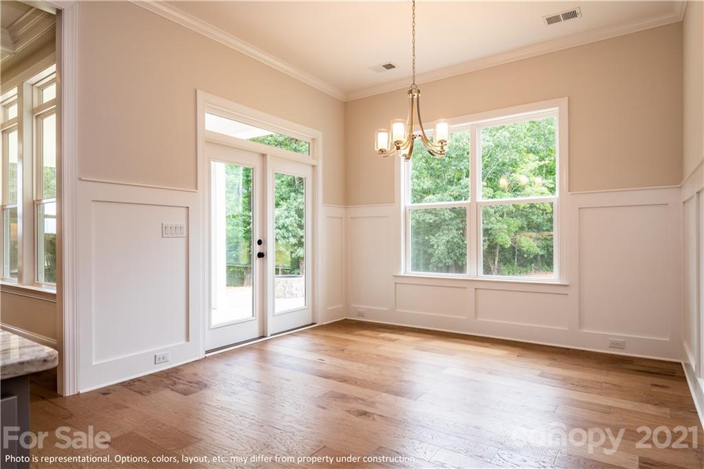 357 Grassy Rdg Court, Unit 50 Clover, SC 29710 - Photo 18 of 27 a view of an empty room with wooden floor and a window