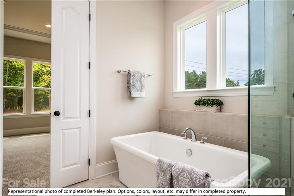 357 Grassy Rdg Court, Unit 50 Clover, SC 29710 - Photo 21 of 27 a white bath tub sitting in a bathroom next to a window