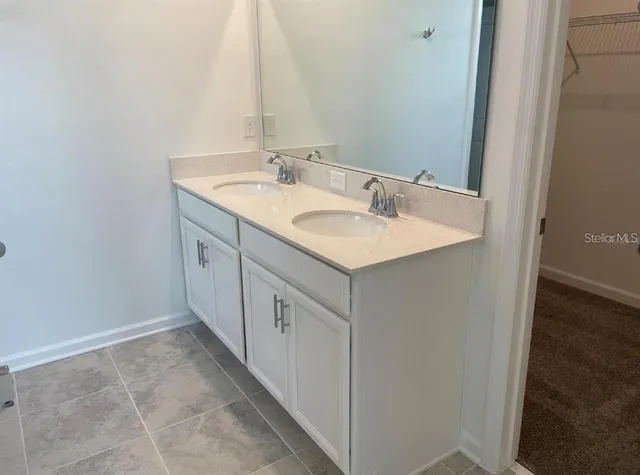 a bathroom with a sink and a mirror