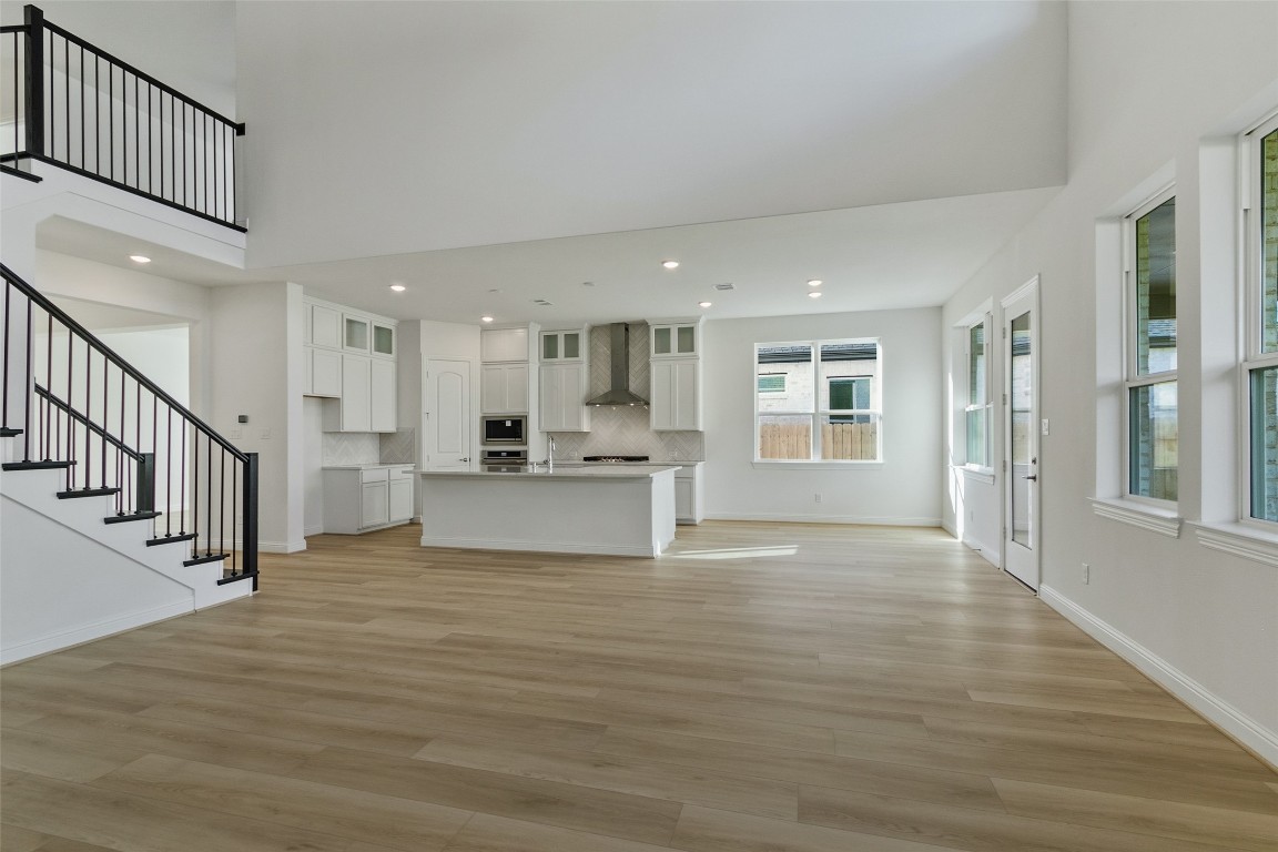 339 Afton June Drive Rosenberg, TX 77471 - Photo 22 of 44 a view of kitchen with kitchen island wooden floor center island and a window