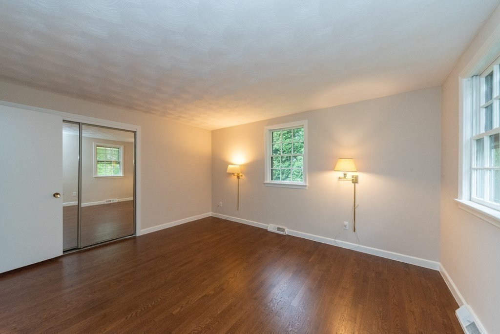 10 Fencourt Road Canton, MA 02021 - Photo 10 of 29 an empty room with wooden floor mirror and windows