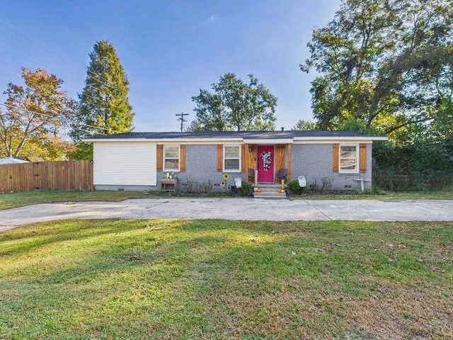 a view of a house with swimming pool and a yard