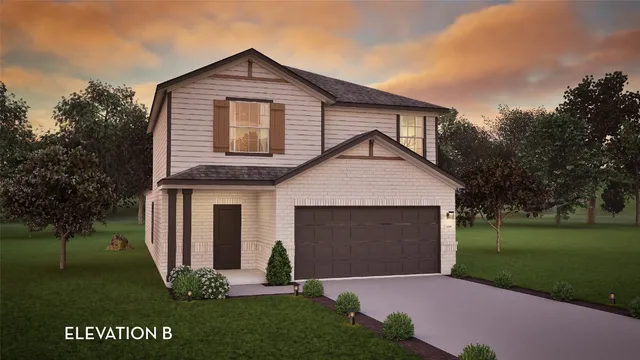 a front view of a house with a garden and yard