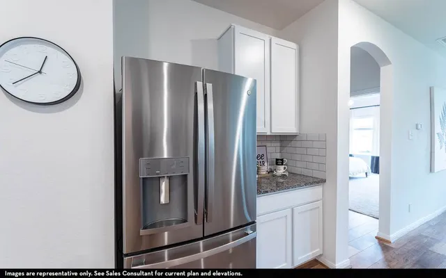 a kitchen with a refrigerator and cabinets