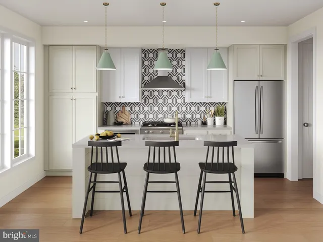 a kitchen with stainless steel appliances kitchen island granite countertop a dining table chairs and a refrigerator