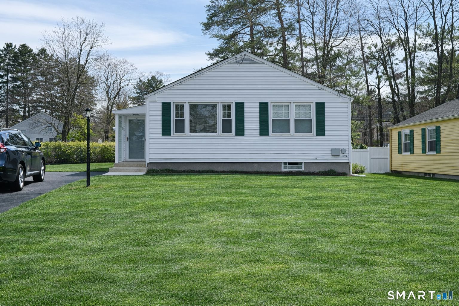 a front view of a house with a garden