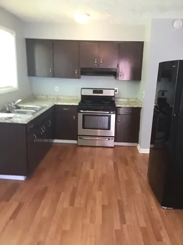 a kitchen with a stove and a refrigerator