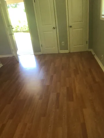 a view of an empty room and wooden floor