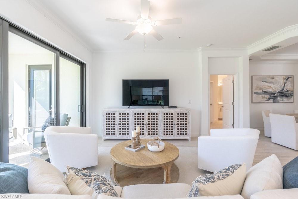 16352 Viansa Way, Unit 10101 Naples, FL 34110 - Photo 11 of 37 a living room with furniture and a window