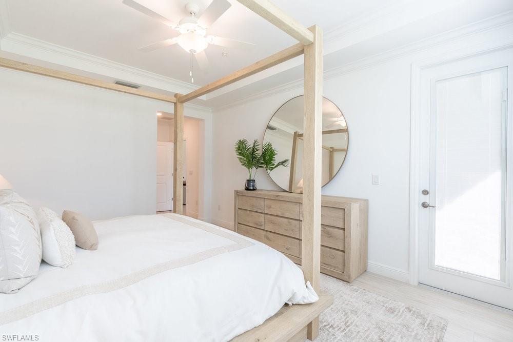 16352 Viansa Way, Unit 10101 Naples, FL 34110 - Photo 14 of 37 a bedroom with a bed and a dresser