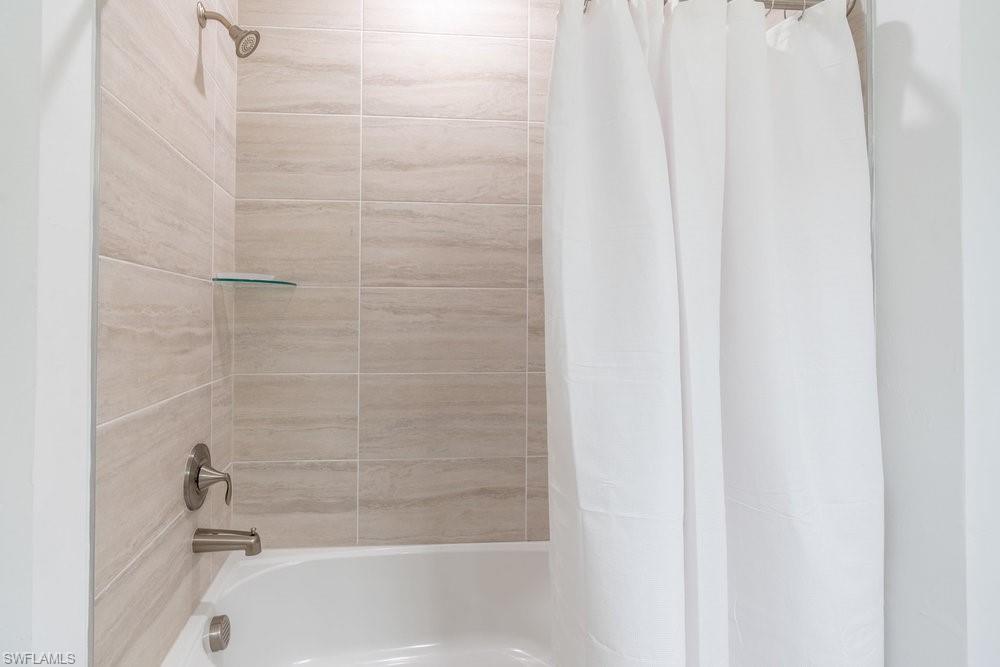 16352 Viansa Way, Unit 10101 Naples, FL 34110 - Photo 18 of 37 a bathroom with a bathtub