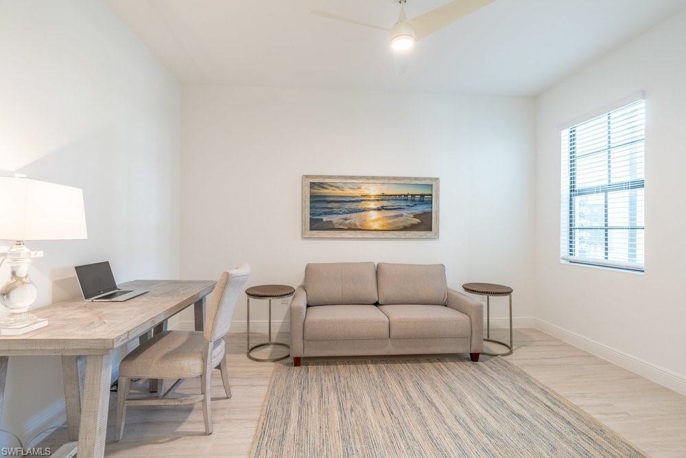16352 Viansa Way, Unit 10101 Naples, FL 34110 - Photo 19 of 37 a living room with furniture and a window