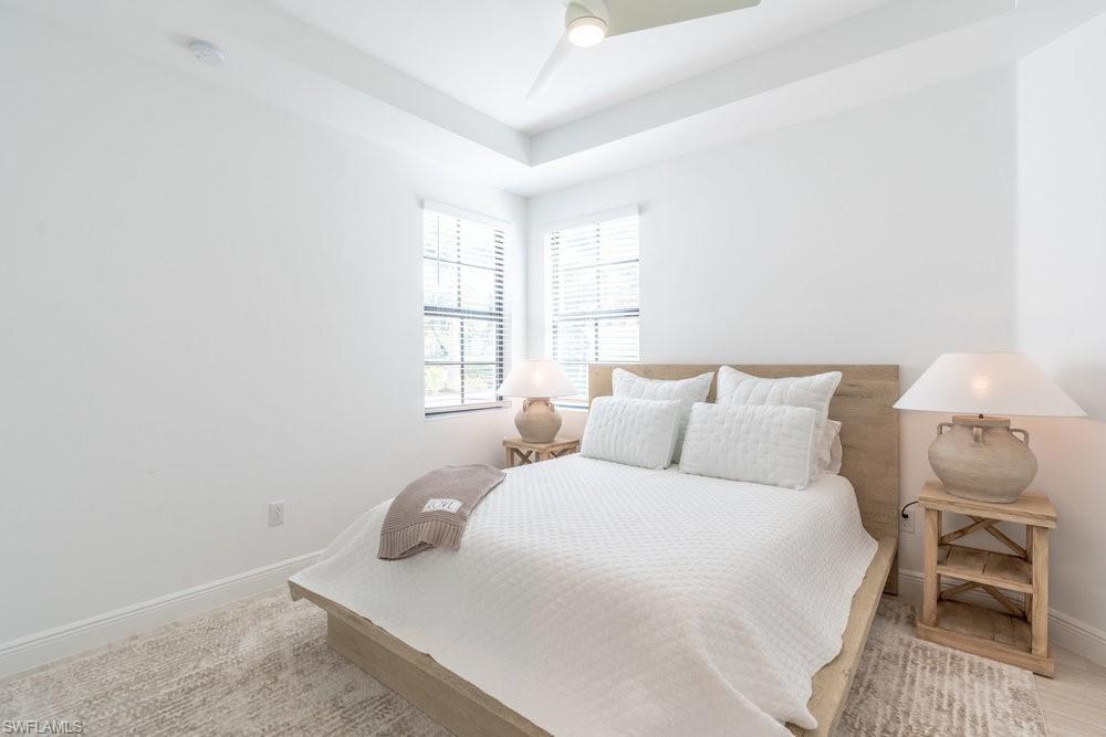 16352 Viansa Way, Unit 10101 Naples, FL 34110 - Photo 20 of 37 a bedroom with a bed and a window