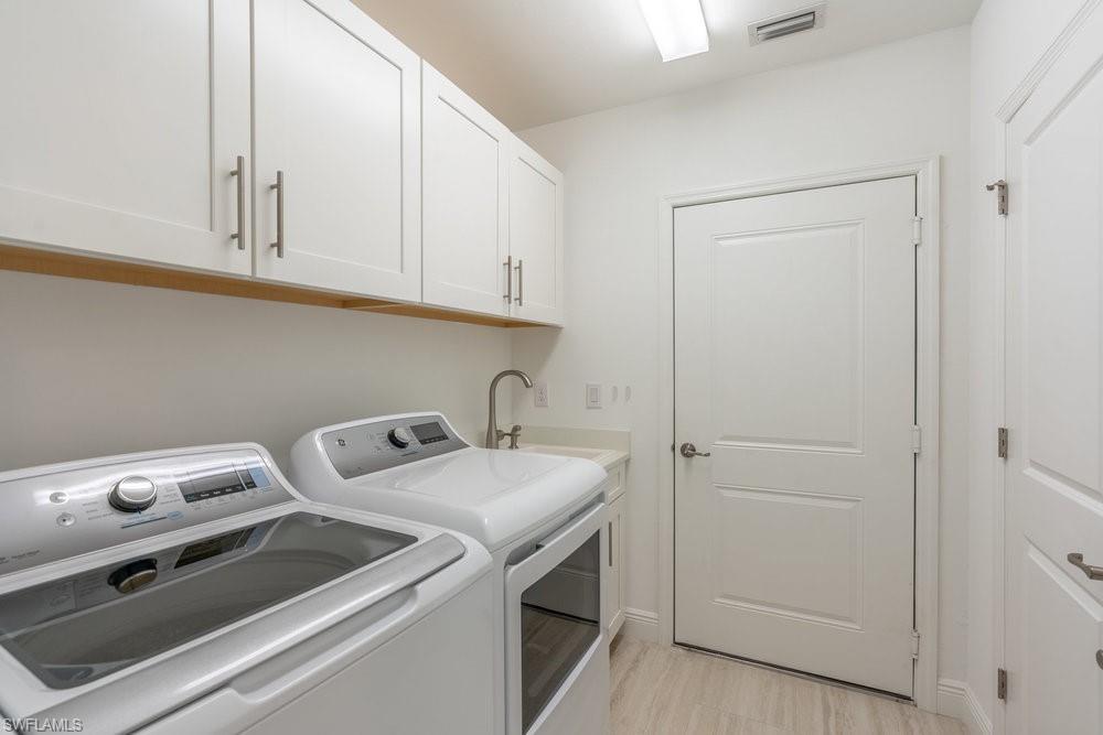 16352 Viansa Way, Unit 10101 Naples, FL 34110 - Photo 22 of 37 a utility room with dryer and washer