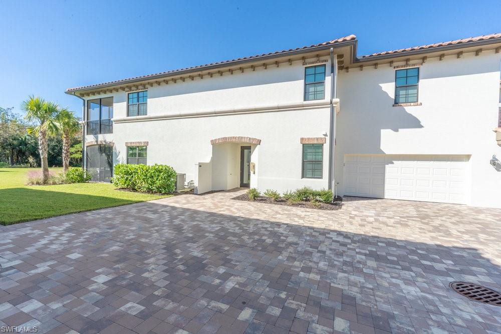 16352 Viansa Way, Unit 10101 Naples, FL 34110 - Photo 25 of 37 a view of a house with a yard
