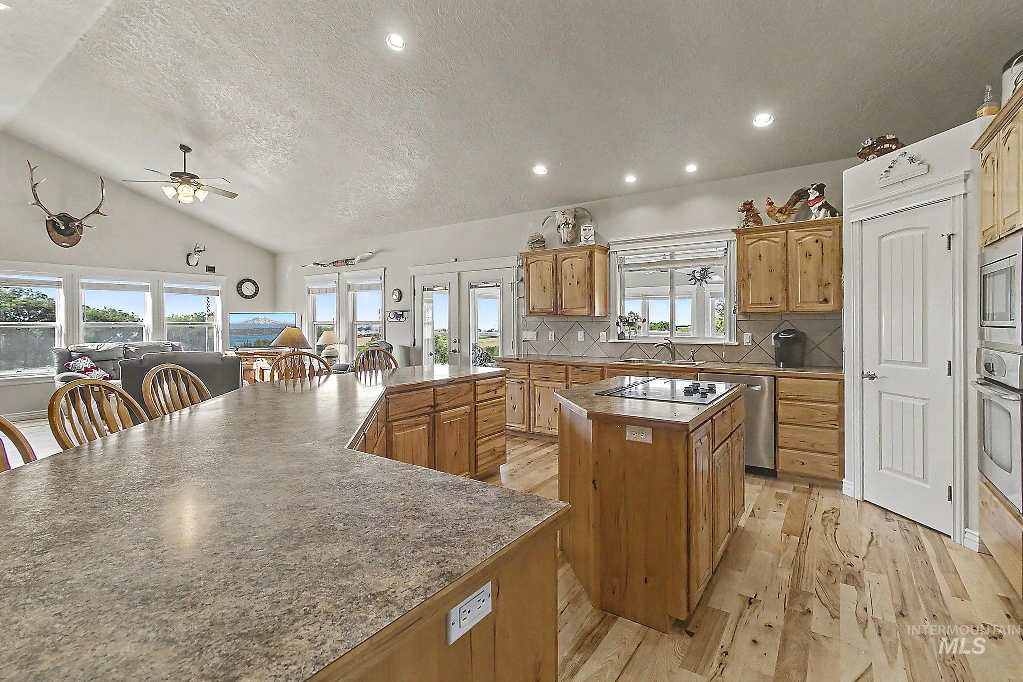 6900 West Charters Lane Melba, ID 83641 - Photo 15 of 49 Open-concept kitchen and living area featuring a vaulted ceiling and recessed lighting