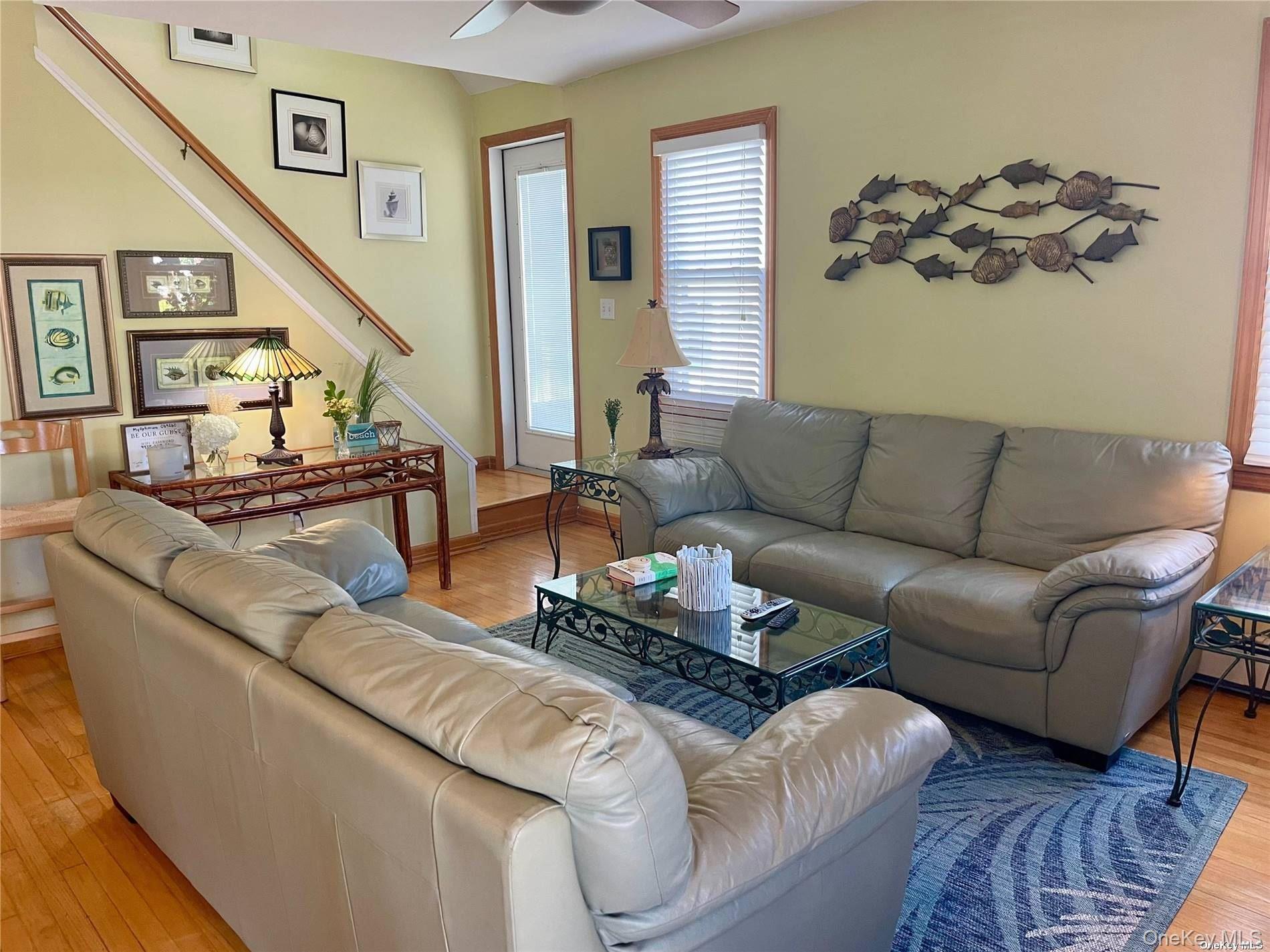 89 Lynbrook Avenue Point Lookout, NY 11569 - Photo 3 of 19 a living room with furniture and wooden floor