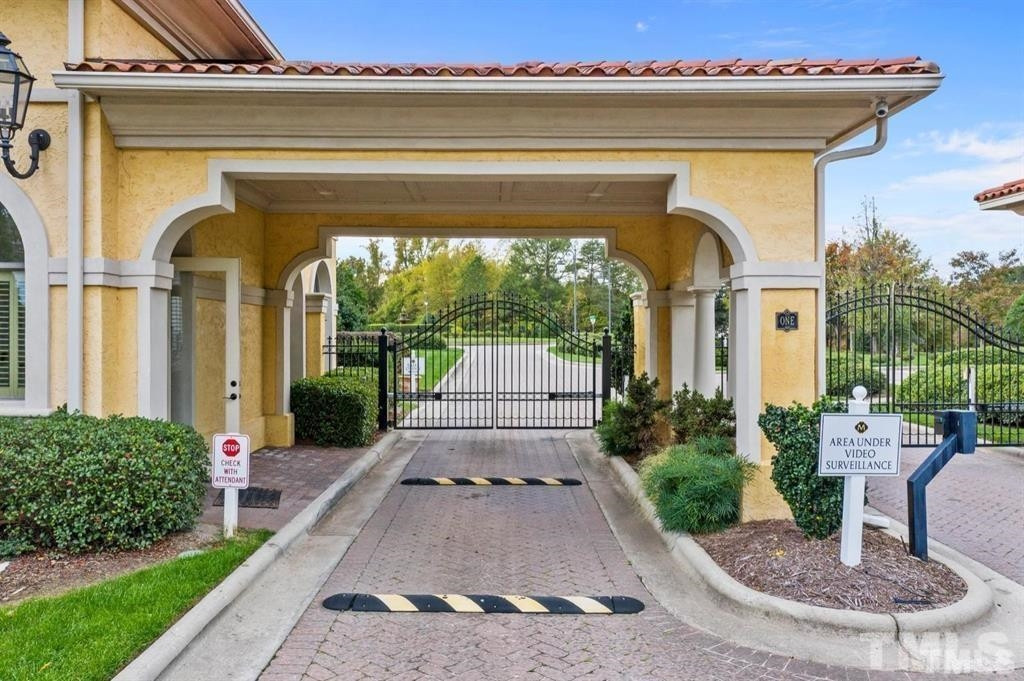 39 Treviso Place Durham, NC 27707 - Photo 18 of 18 a view of a house with a small yard plants and a large tree