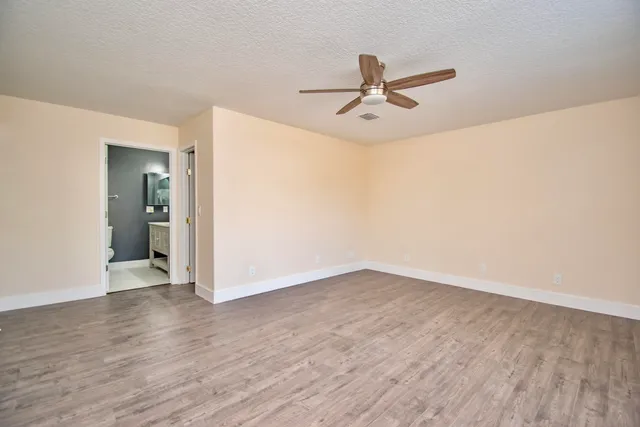 a bathroom with a toilet a window and tub