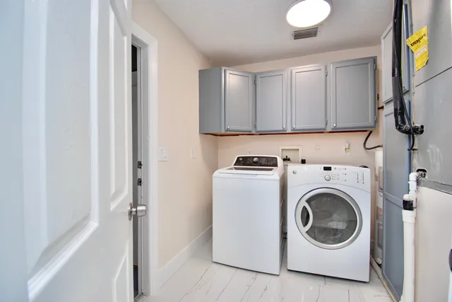 a view of an house with backyard and tree