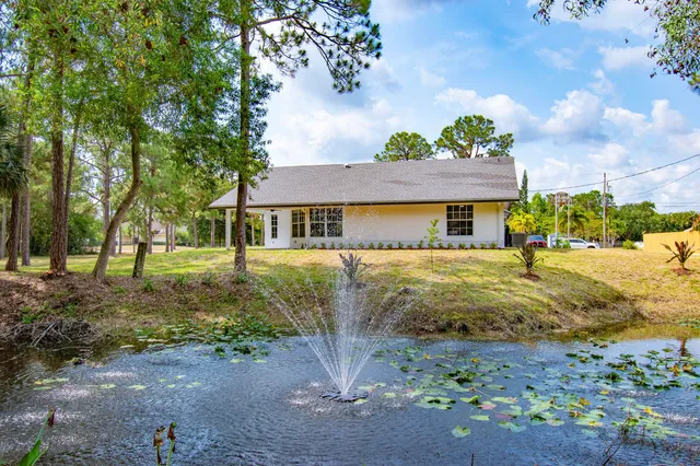 a view of a house with backyard and porch