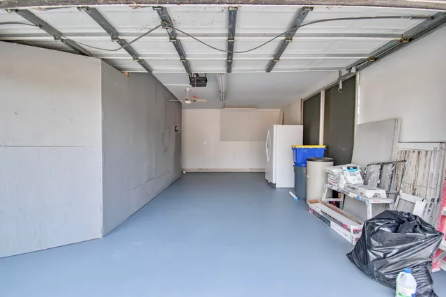 a view of a house with a yard and large trees