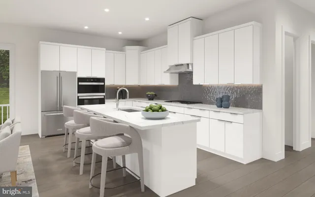 a kitchen with stainless steel appliances kitchen island a white table chairs and a refrigerator