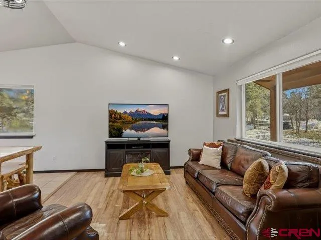 a bathroom with a granite countertop toilet sink and mirror