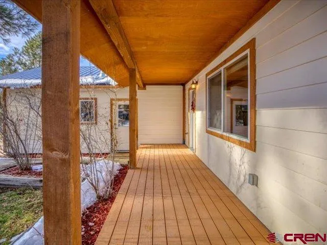 a kitchen with stainless steel appliances granite countertop a refrigerator a sink dishwasher a stove and white countertops with wooden floor