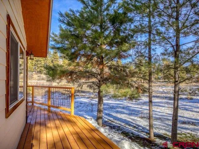 a living room with stainless steel appliances kitchen island granite countertop furniture and a chandelier