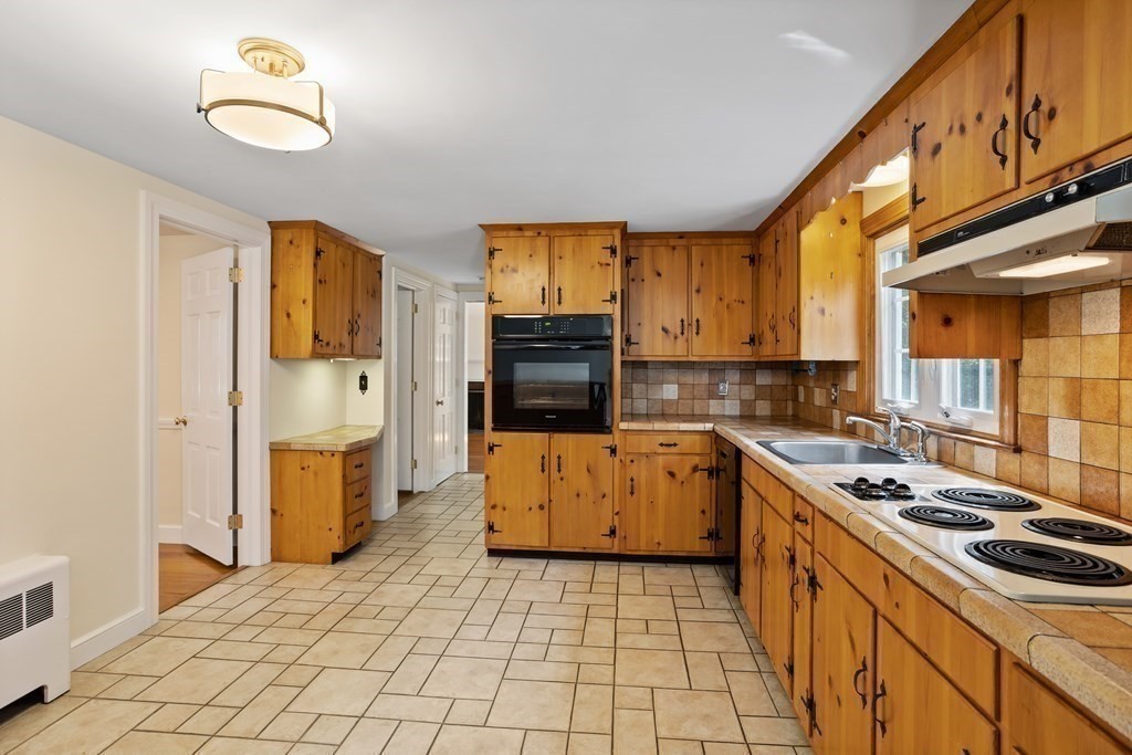 2 Jefferson Drive Acton, MA 01720 - Photo 15 of 38 a kitchen with a stove a sink and a refrigerator