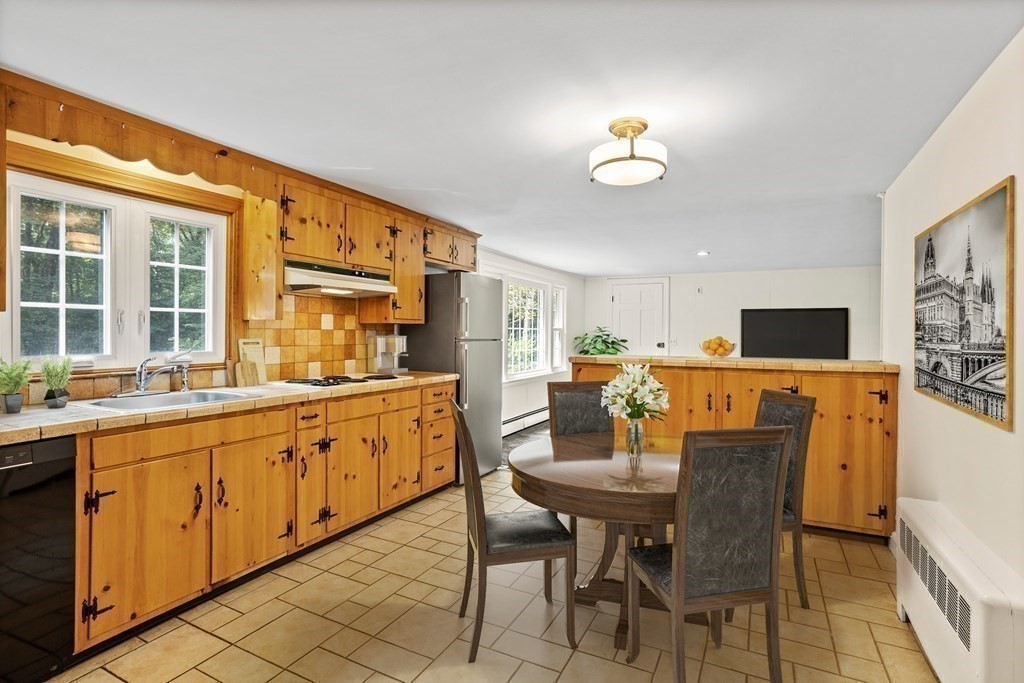 2 Jefferson Drive Acton, MA 01720 - Photo 16 of 38 a view of a dining room with furniture a livingroom and chandelier