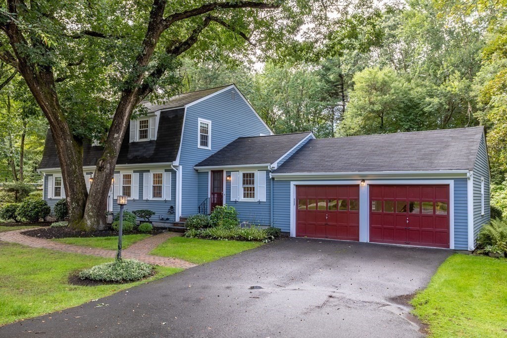 2 Jefferson Drive Acton, MA 01720 - Photo 2 of 38 a front view of a house with a yard and garage