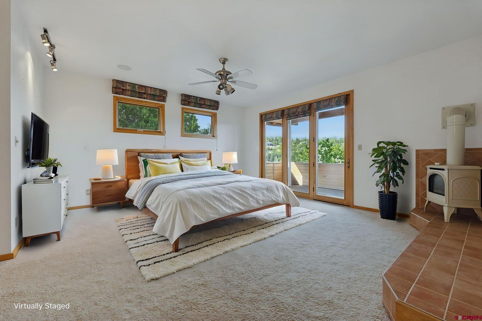 481 Far View Road Durango, CO 81303 - Photo 16 of 45 a spacious bedroom with a bed and a couch