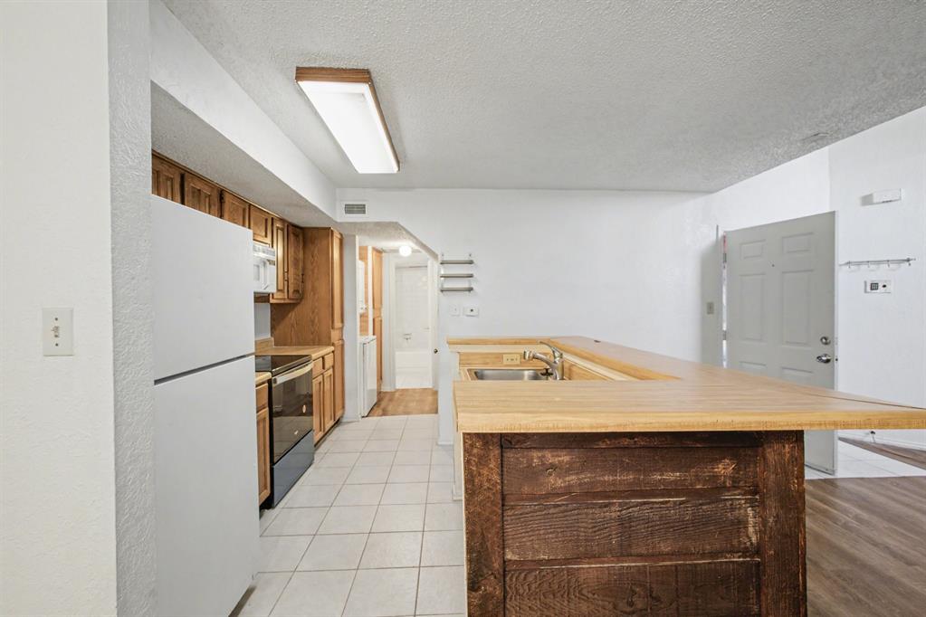 9827 Walnut Street, Unit 210 Dallas, TX 75243 - Photo 11 of 30 a utility room with washer and dryer