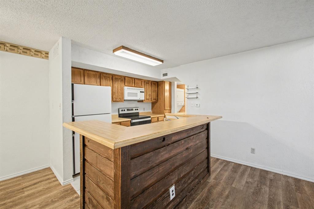9827 Walnut Street, Unit 210 Dallas, TX 75243 - Photo 12 of 30 a kitchen with a stove and a sink